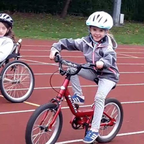 Girl riding bike on track
