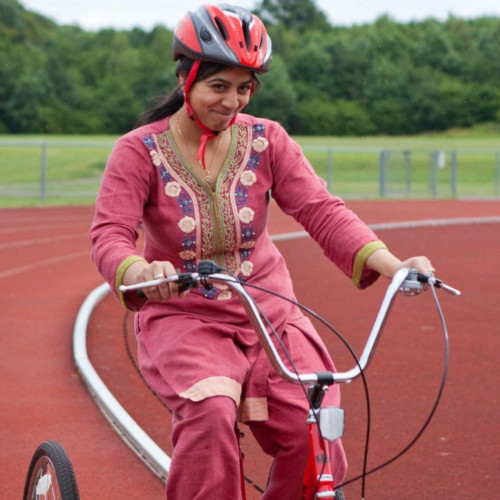 Lady cycling round track thumbnail